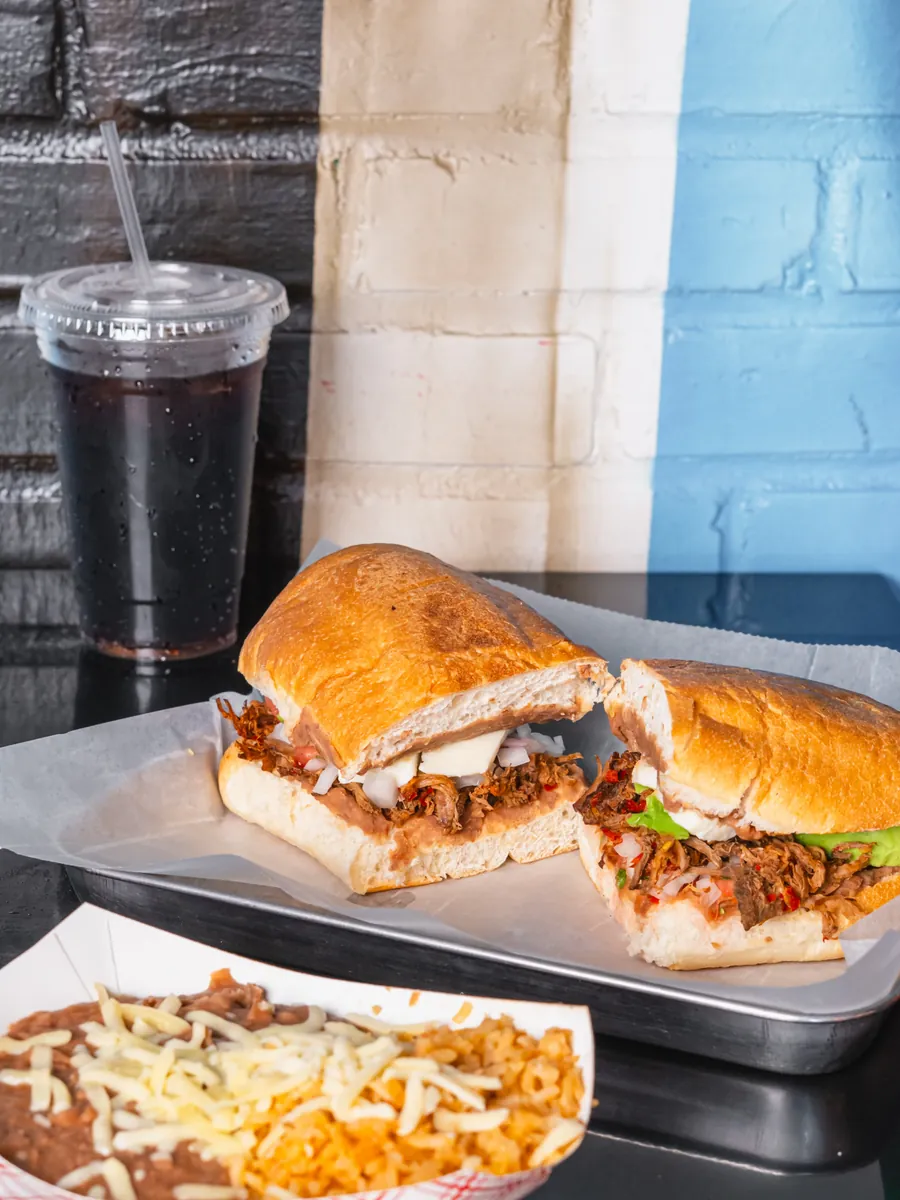 A loaded Mexican torta, cut in half